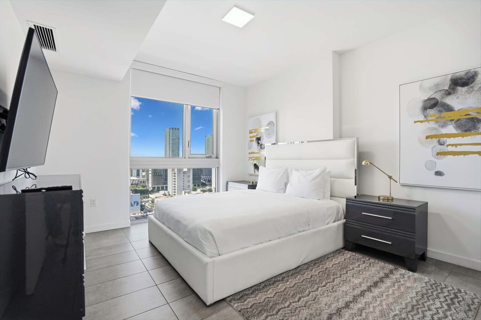 Cozy and bright bedroom with soft lighting and fresh linens.