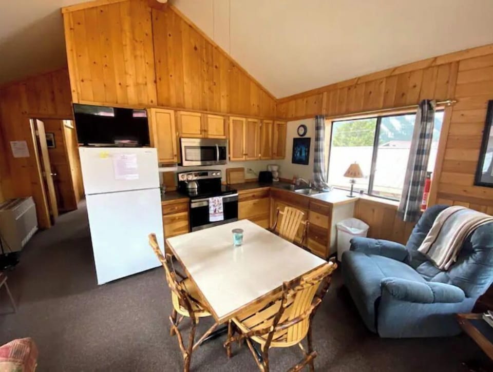 Kitchen with full size stove range, oven, microwave, fridge, coffee maker. 