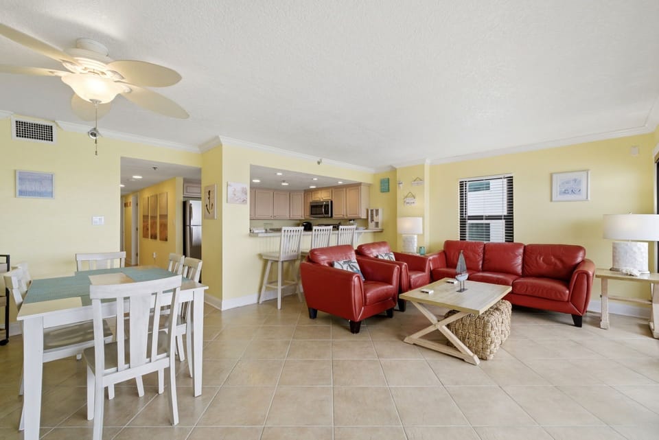 Ocean Breeze E601- Settle into your inviting open-concept living space, where sunny yellow walls and coastal charm create a cheerful, relaxing atmosphere. You'll love the seamless flow from dining to kitchen to living area—perfect for your beach vacation.