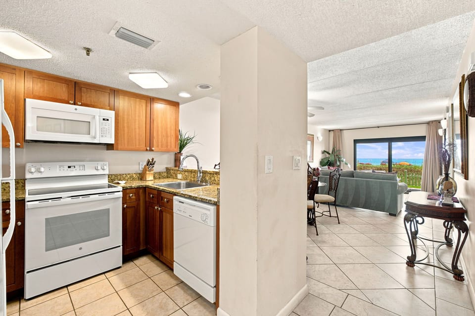 Ocean Breeze W 105- Your fully equipped kitchen flows into a bright living space with stunning ocean views just beyond. Warm wood cabinetry and modern appliances make meal prep a breeze while you soak in the coastal backdrop.