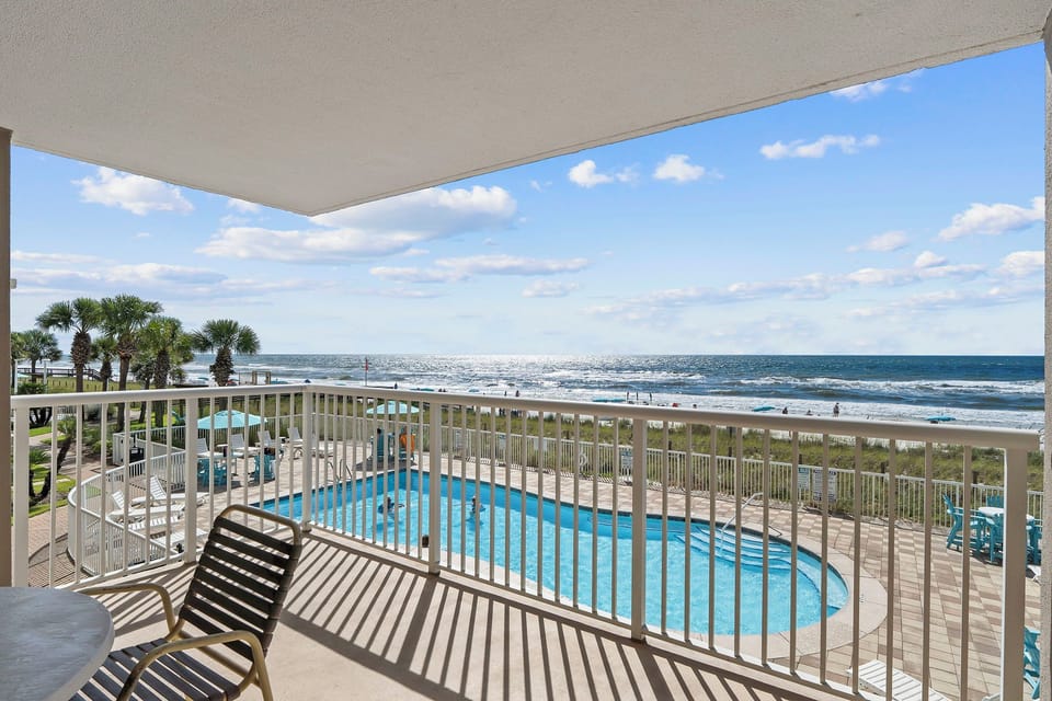 Sandy Key 235- Your private balcony opens to sweeping ocean and pool views, where the sound of waves and sparkling blue water create the perfect backdrop for your morning coffee or sunset relaxation.