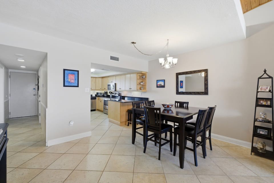 Shipwatch D803- A bright, open-plan space where your kitchen flows into the dining area, perfect for preparing and enjoying meals together. The elegant chandelier and thoughtful decor create a welcoming atmosphere for your vacation dining moments.