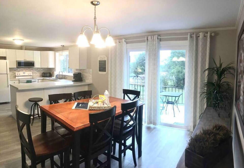 Dining area with adjoined kitchen as well as outside balcony