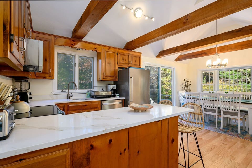 View of kitchen and dining areas from hallway entry