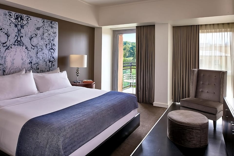 Breathe in morning light from your room’s private balcony door.