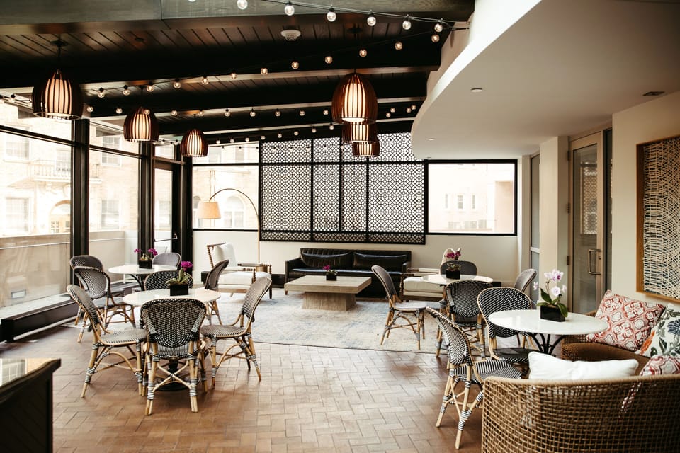 Relax with friends in a cozy lounge beside city-facing windows.