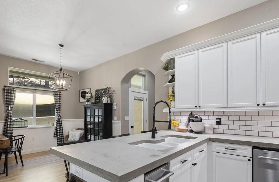 Beautiful polished concrete kitchen counter.  Book shelf has books & board games