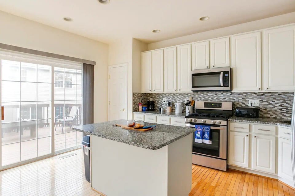 Front view of the kitchen that leads to the deck area through sliding doors.