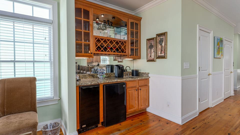 You'll love this elegant wet bar featuring granite counters, wine storage, and dual appliances for entertaining.