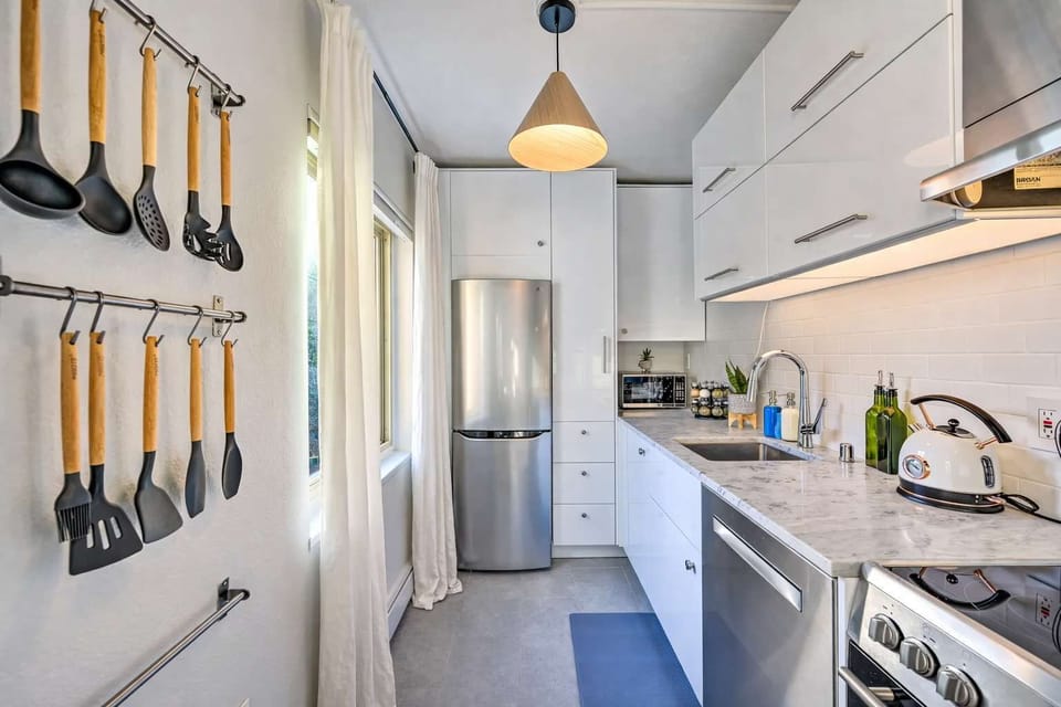 Bright galley kitchen with modern appliances and handy cookware, perfect for easy home-style meals.