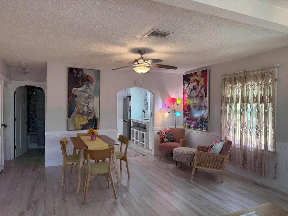 Dining and sitting area shows arches to kitchen and bath 1.