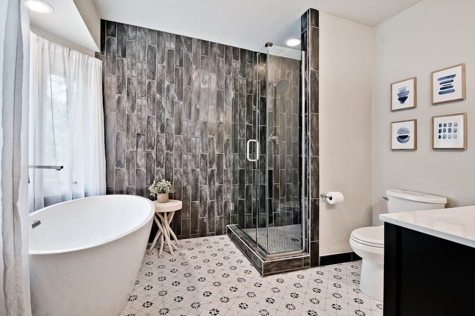 Soaking tub tiled shower and natural lighting makes this a true oasis