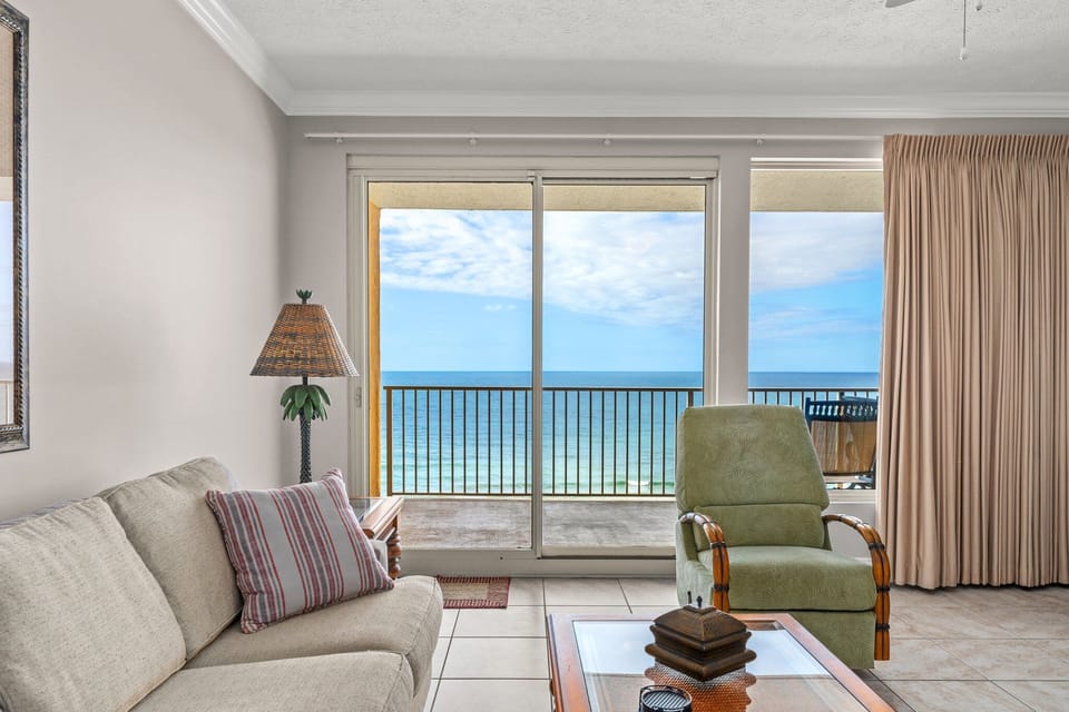 Relax in this living room with ocean views through large sliding glass doors.