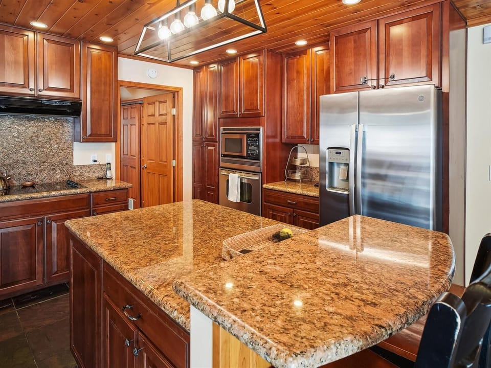 Gourmet kitchen with granite countertops and stainless steel appliances, perfect for home-cooked meals.