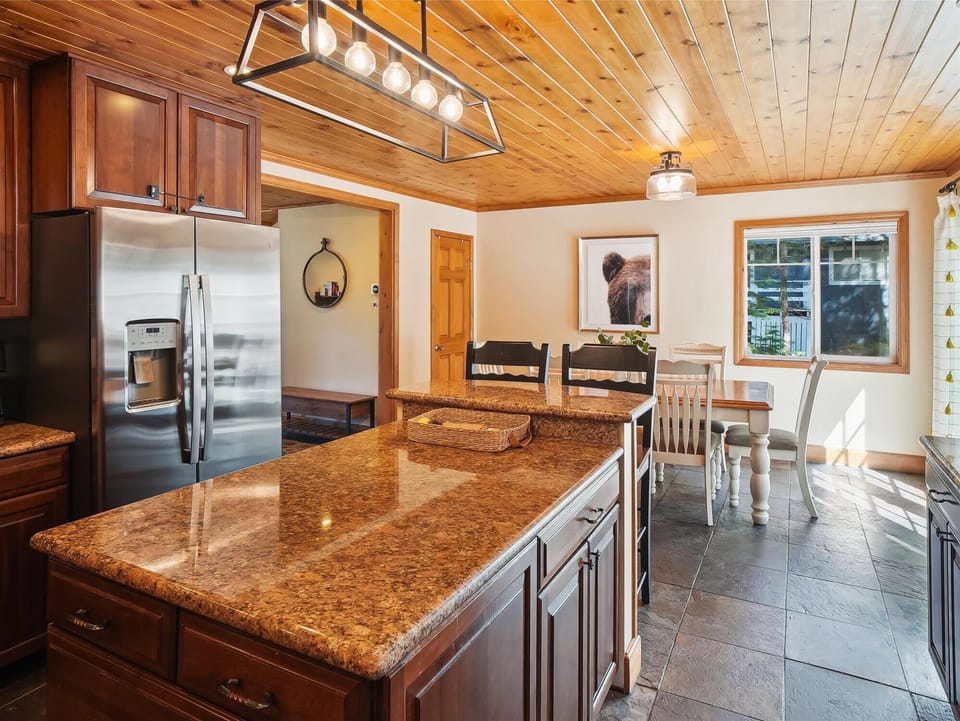Modern kitchen with a large granite island and all the amenities needed for gourmet cooking.