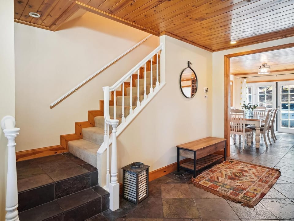 Charming staircase with rustic accents, leading to the cozy bedrooms upstairs.