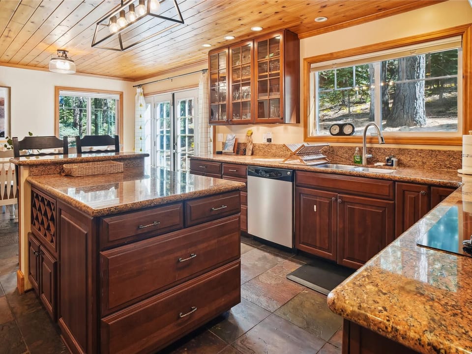 Fully equipped kitchen with granite countertops and a spacious island for easy meal prep.