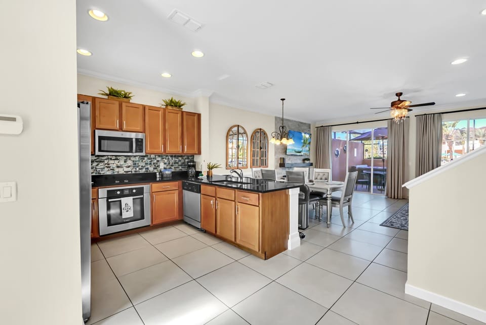 Large, open kitchen with stainless steel appliances and solid surface countertops