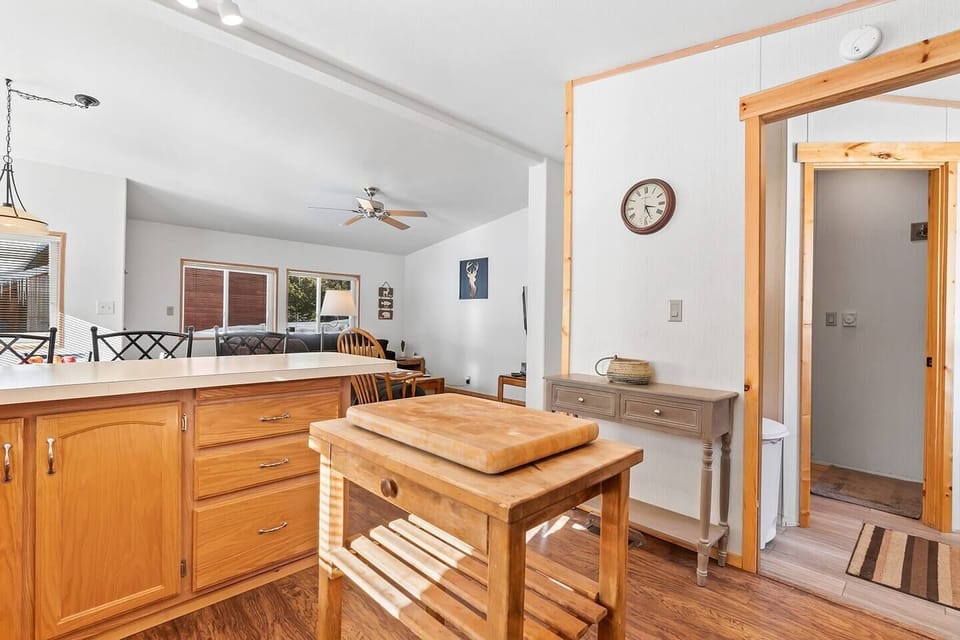 Savor the seamless connection between the kitchen and living room, where the open layout invites a fluid transition, creating a harmonious and inviting atmosphere at Valley Creek Cabin.