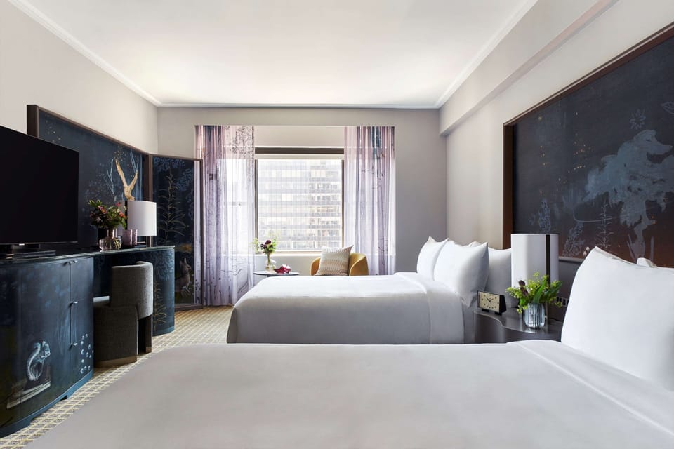 Settle in together with two plush beds and bright city light.