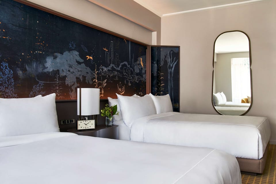 Recharge in bright, airy comfort with thoughtfully placed bedside lighting.
