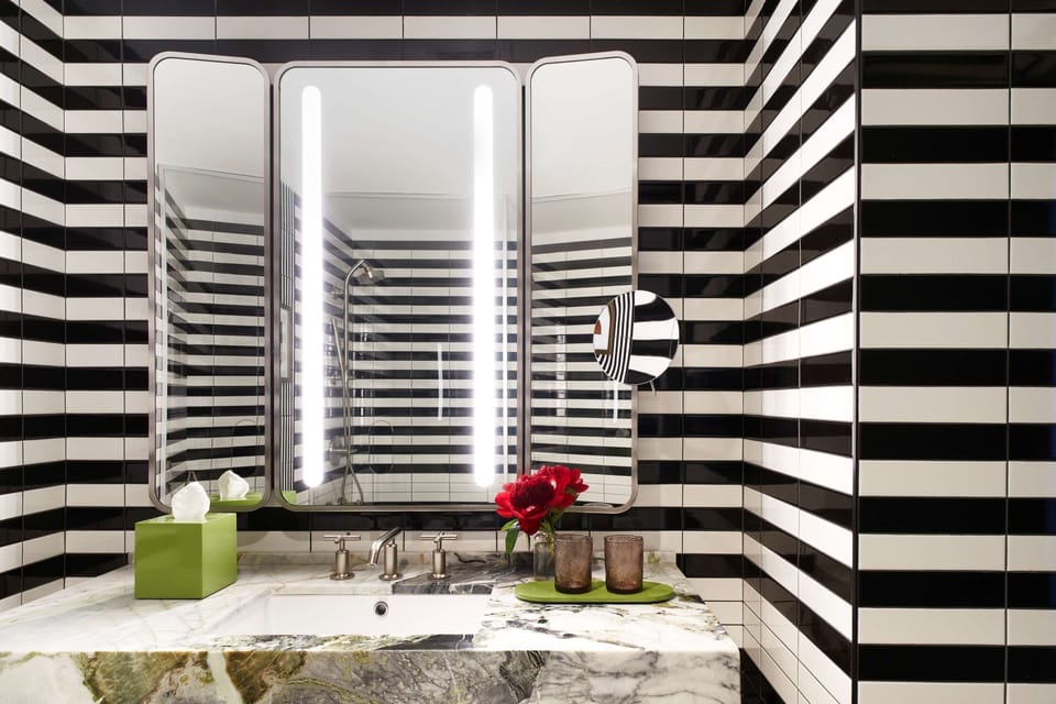 Refresh in a bold, spa-like bath with glowing mirrors.