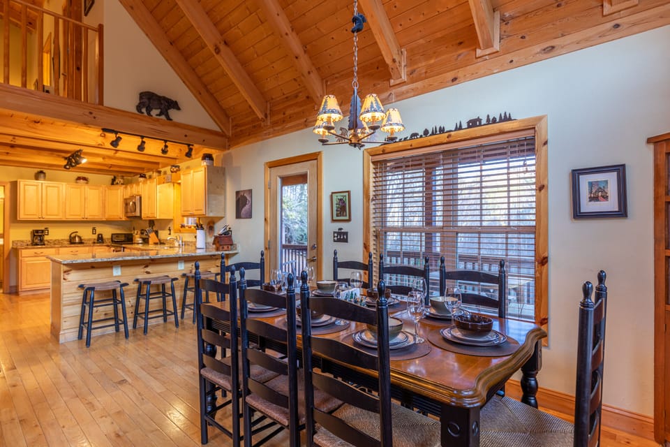 Gather the whole crew around the large dining table, set for eight beneath soaring wood beams and a rustic chandelier.
