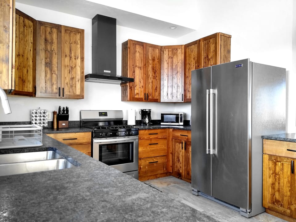 This home's kitchen features granite and stainless steel, with all appliances