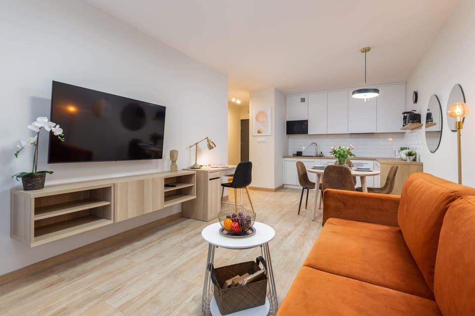A seating area with an extremely comfortable sofa and TV.