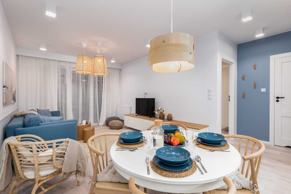 A larger perspective of the open-plan living area, featuring the dining table and comfortable seating arrangements.