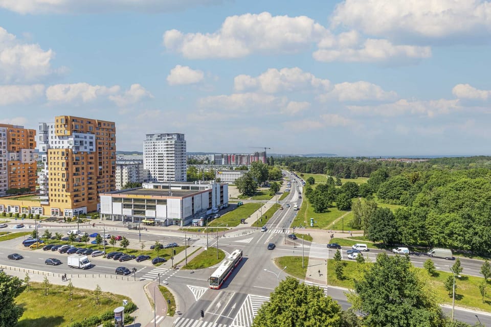 An aerial view of the residential complex surrounded by a lush forest.