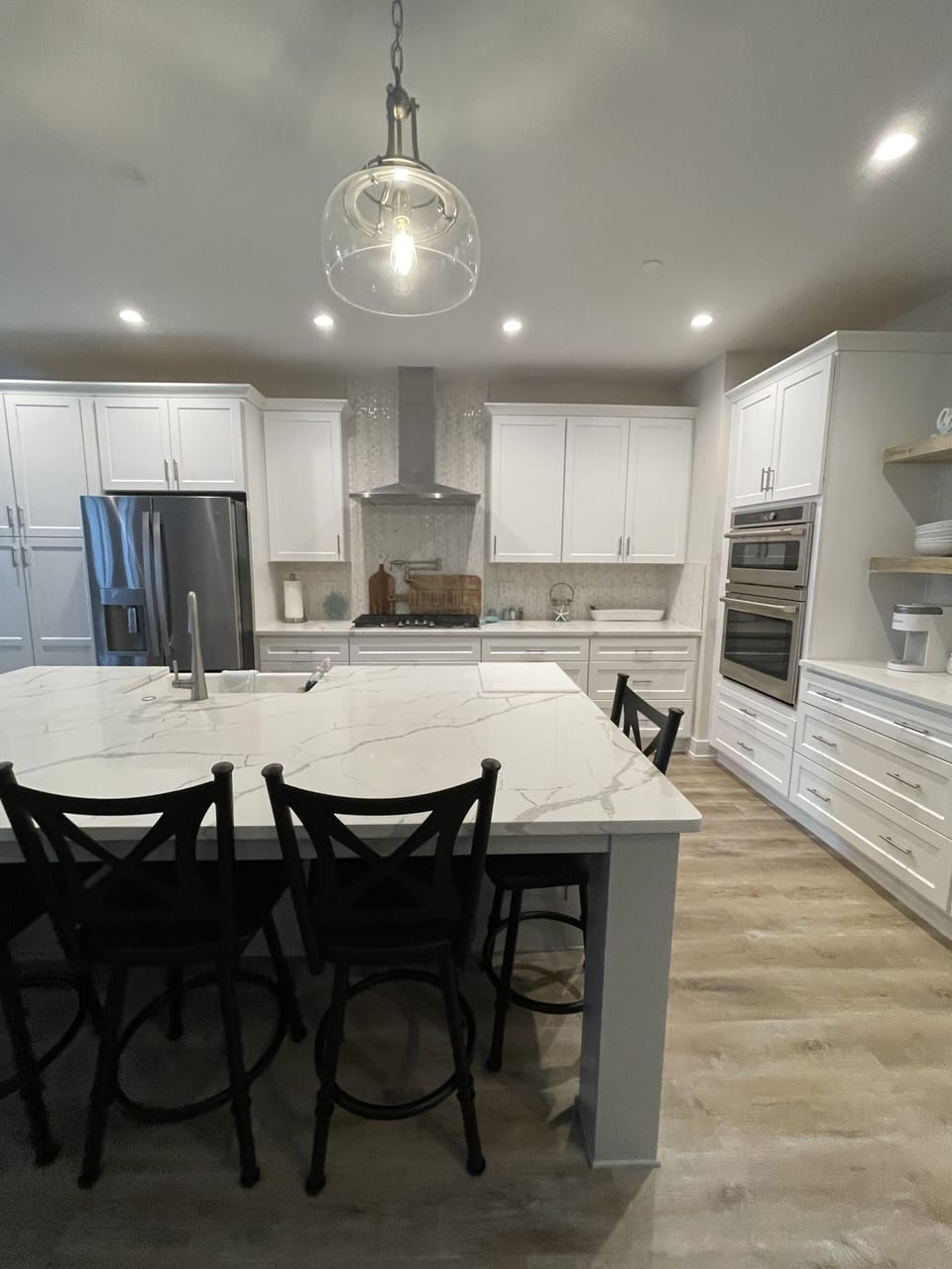 Fully stocked chef kitchen with 5-burner gas stove, double ovens/microwave.