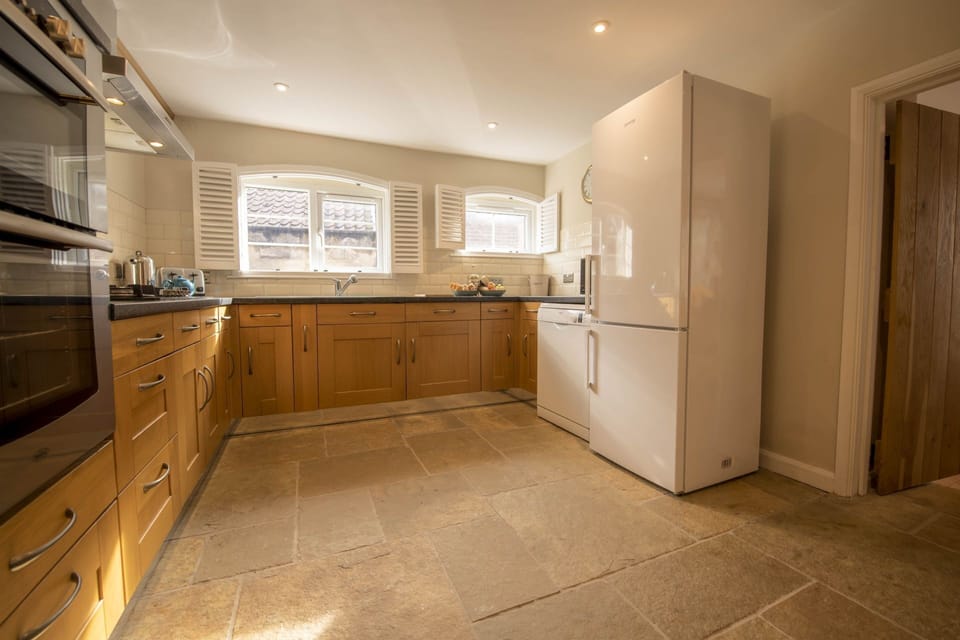 Ground floor: Light floods the well-equipped kitchen overlooking the patio area