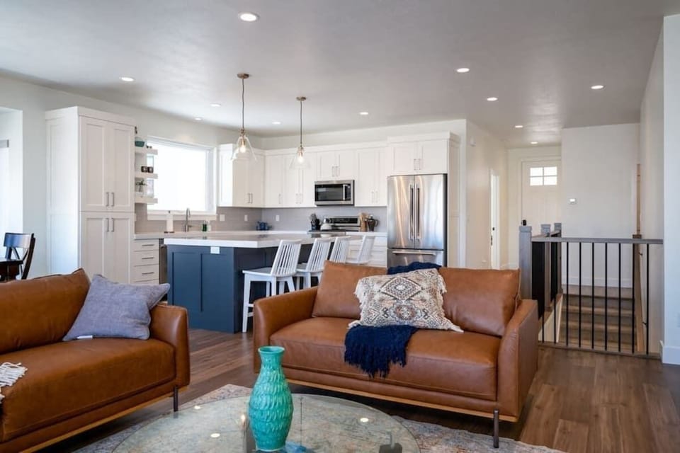 The open-concept living space, complete with a dining area, facilitates effortless conversation with family and friends.