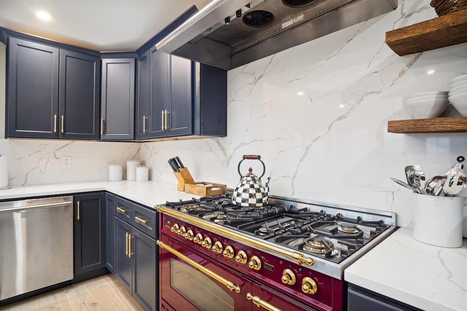 Gourmet 8 burner gas stove with dual ovens.