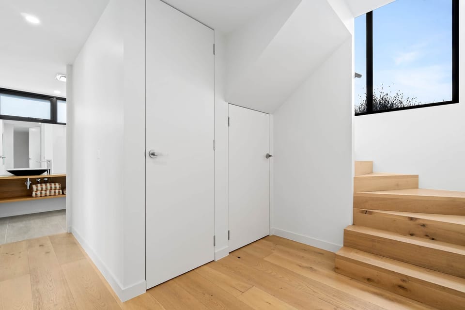 Stairwell to upper living area, Euro style cupboard laundry