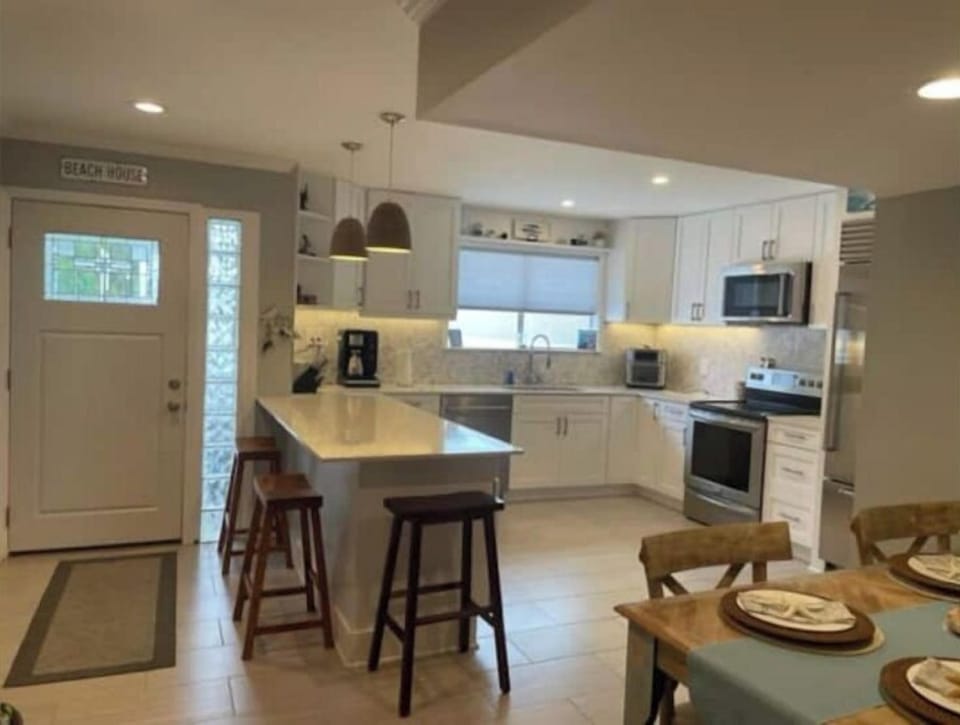 Kitchen.  Counter has 3 stools for dining.