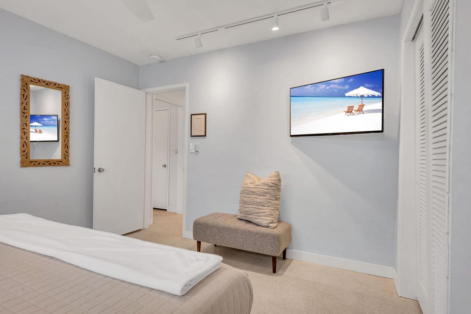 The second bedroom boasts a king size bed and a smart TV.