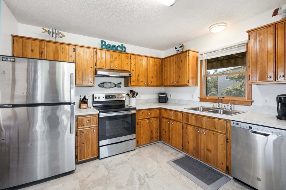 The fully equipped kitchen offers everything you need to prepare meals, with ample counter space and modern appliances perfect for cooking fresh local seafood.
