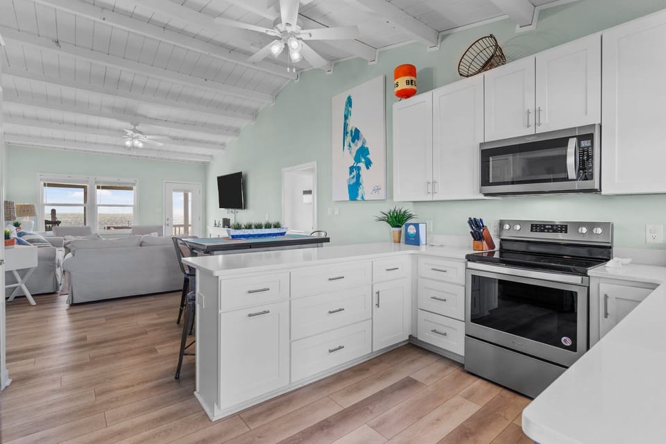Kitchen with quarts counterrops and living area.