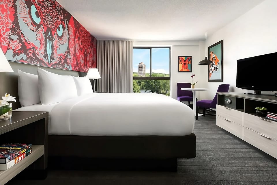 Lounge in a stylish king room with striking art and skyline glimpses.