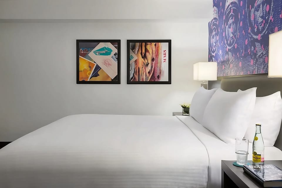 Drift off in fresh linens surrounded by gallery-style artwork.