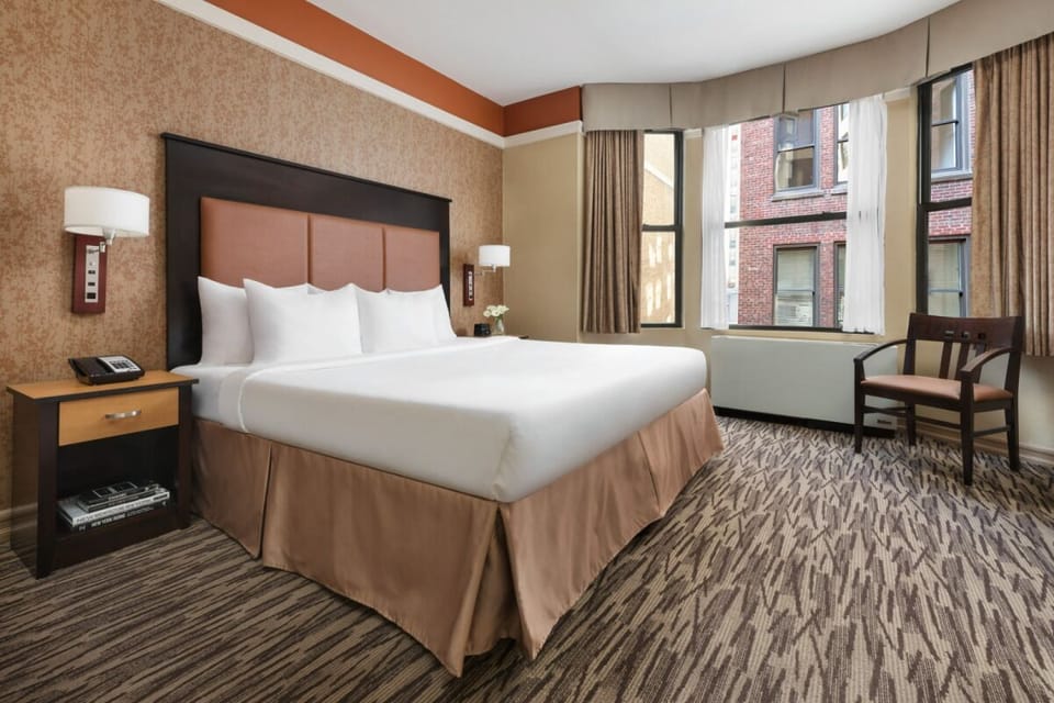 Relax in a comfortable king room framed by city windows.