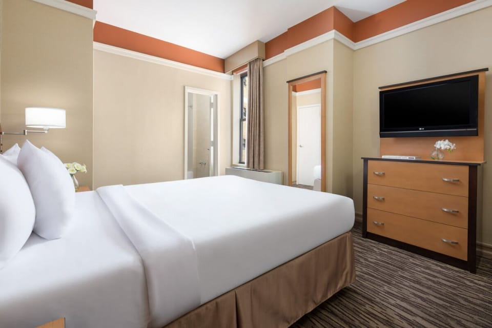 Kick back with in-room TV and generous dresser storage space.