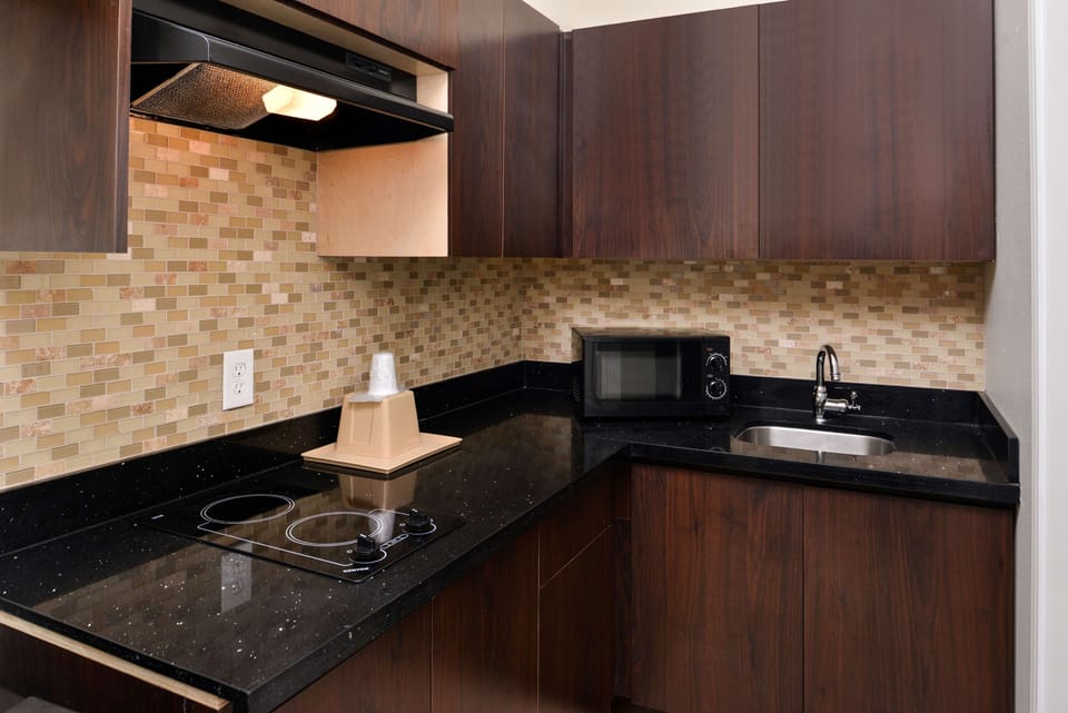 Fix easy snacks in the sleek kitchenette with cooktop.