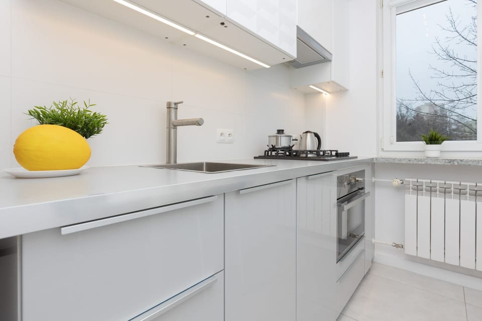 A wide-angle view of the kitchen, showcasing its modern design, spacious countertops, and clean lines.
