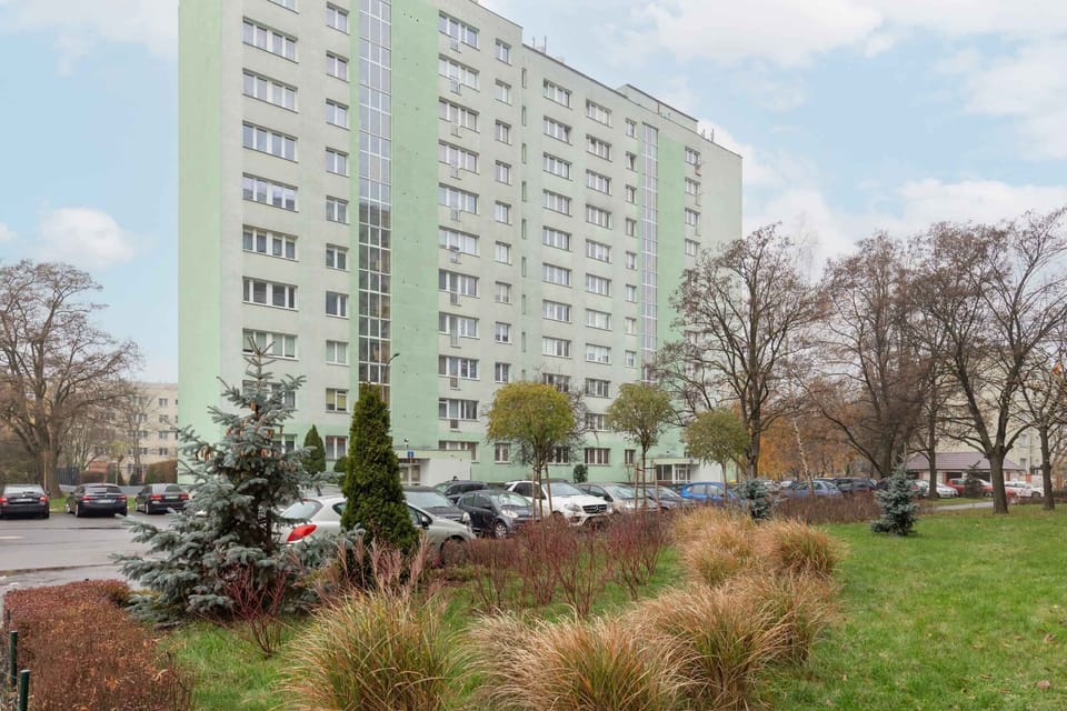 A view of the property’s exterior, showing a green space and nearby walking paths.