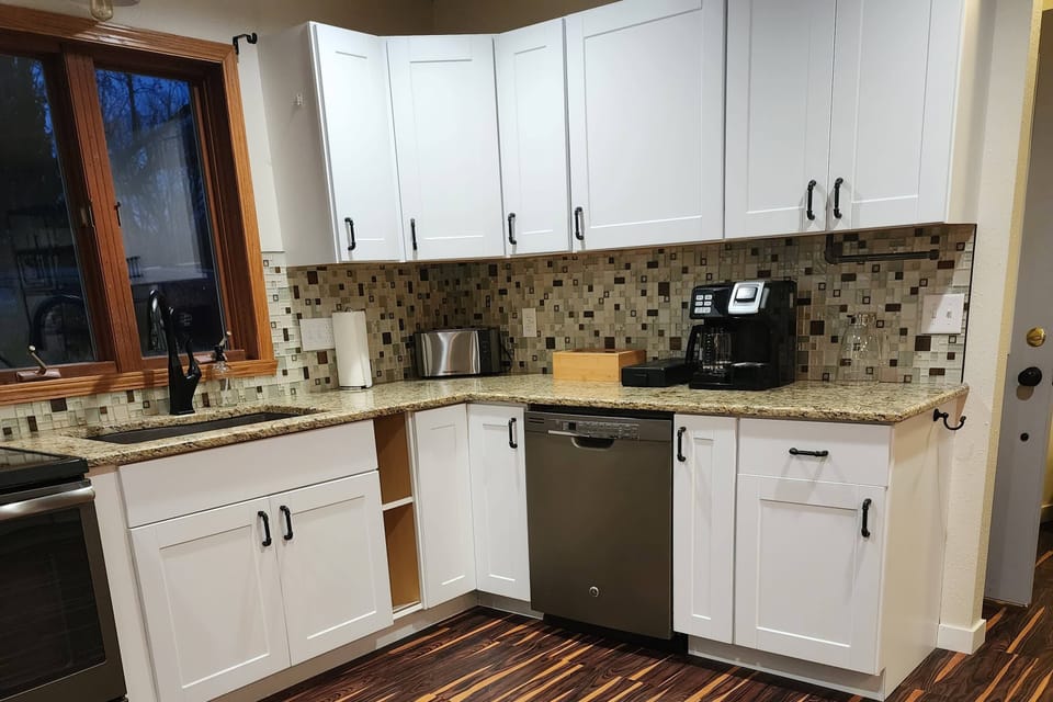 Plenty of counter space with a stocked coffee, coffee maker and a toaster!