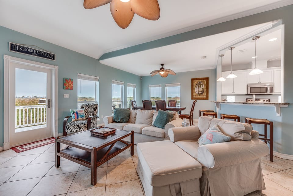 Living Area - From the large, elegant windows to the attractive furniture, you and your guests will love spending time together in this bright and airy living area.
