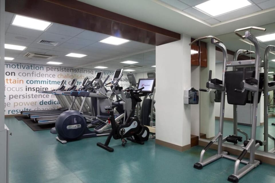 Energize your day with cardio machines in a mirrored gym.